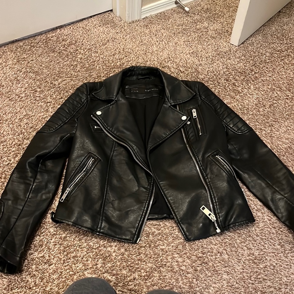 Leather jacket with stitching detail.